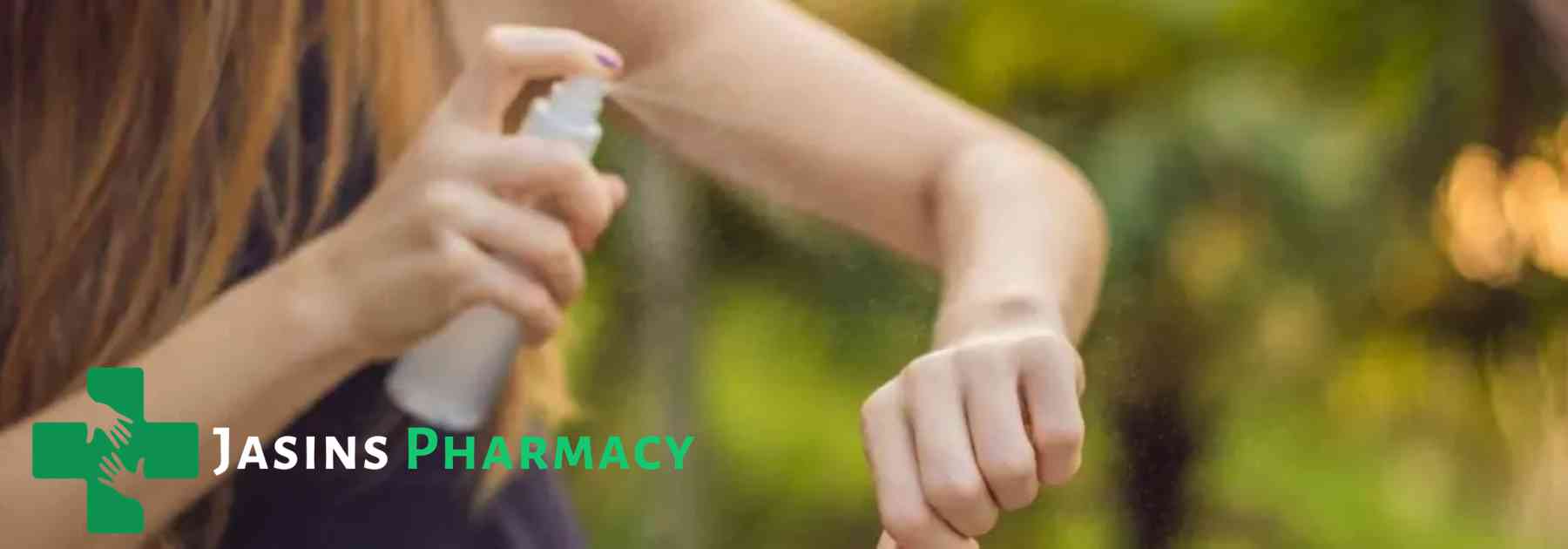woman spraying insect repellent on her arm