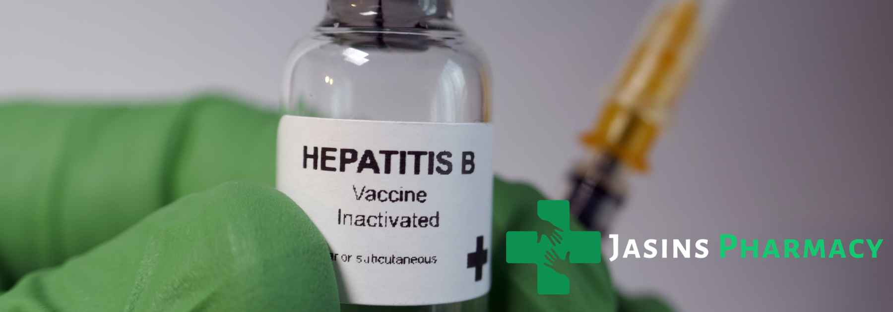 person wearing medical glove holding hepatitis b vaccine