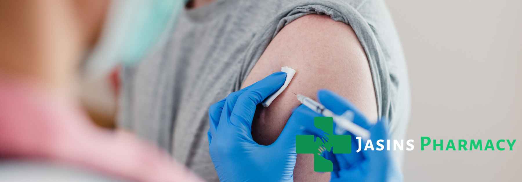 patient in grey shirt receiving vaccine