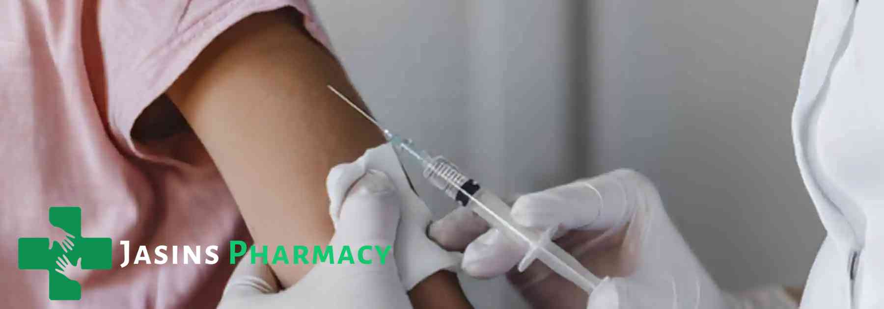 patient in pink shirt receiving vaccine in arm