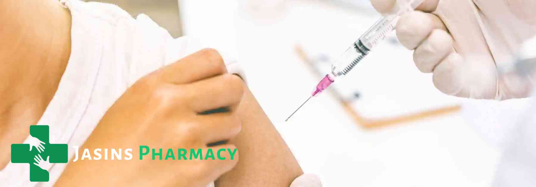 patient wearing white shirt receiving vaccine in arm