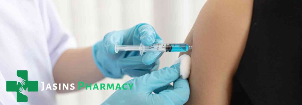 person in black shirt receiving vaccine