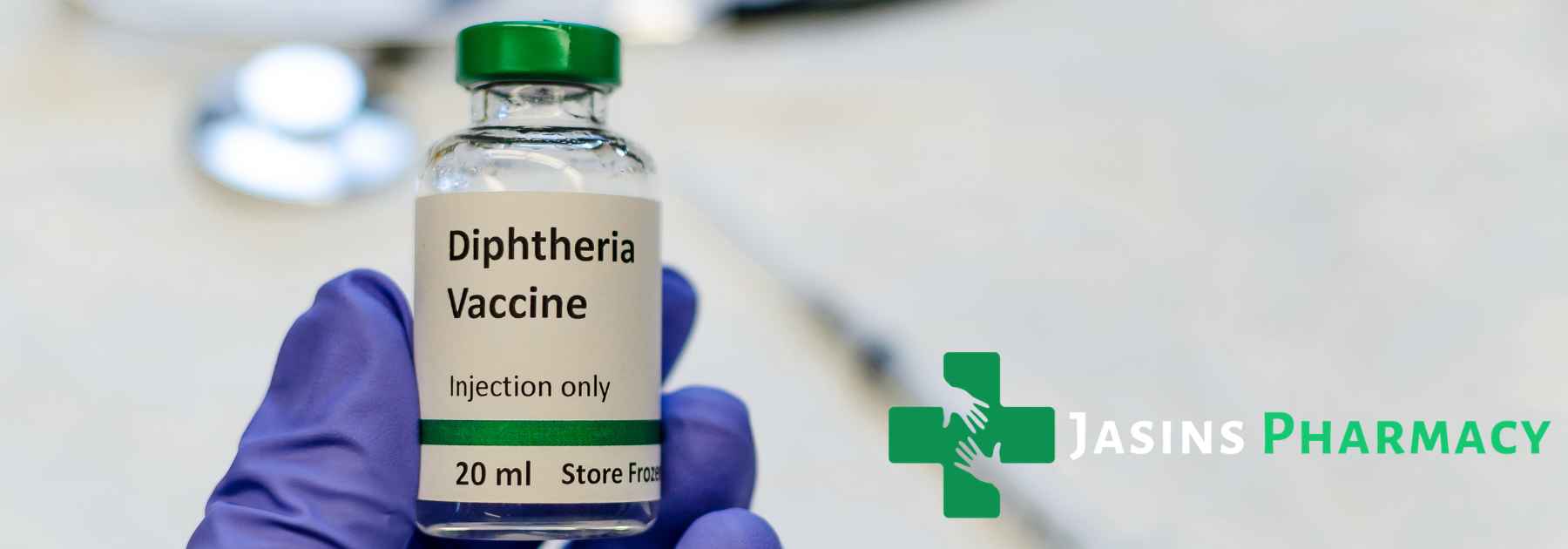 person wearing blue medical glove holding vaccine solution
