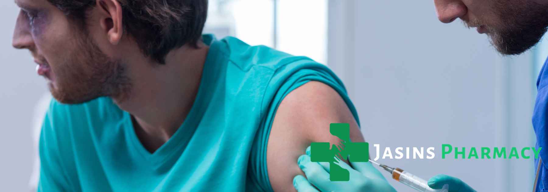 male patient in blue shirt receiving vaccine