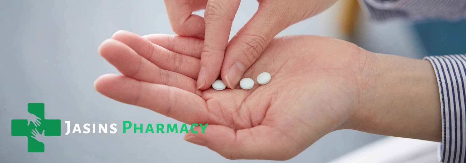person holding white pills in their hand
