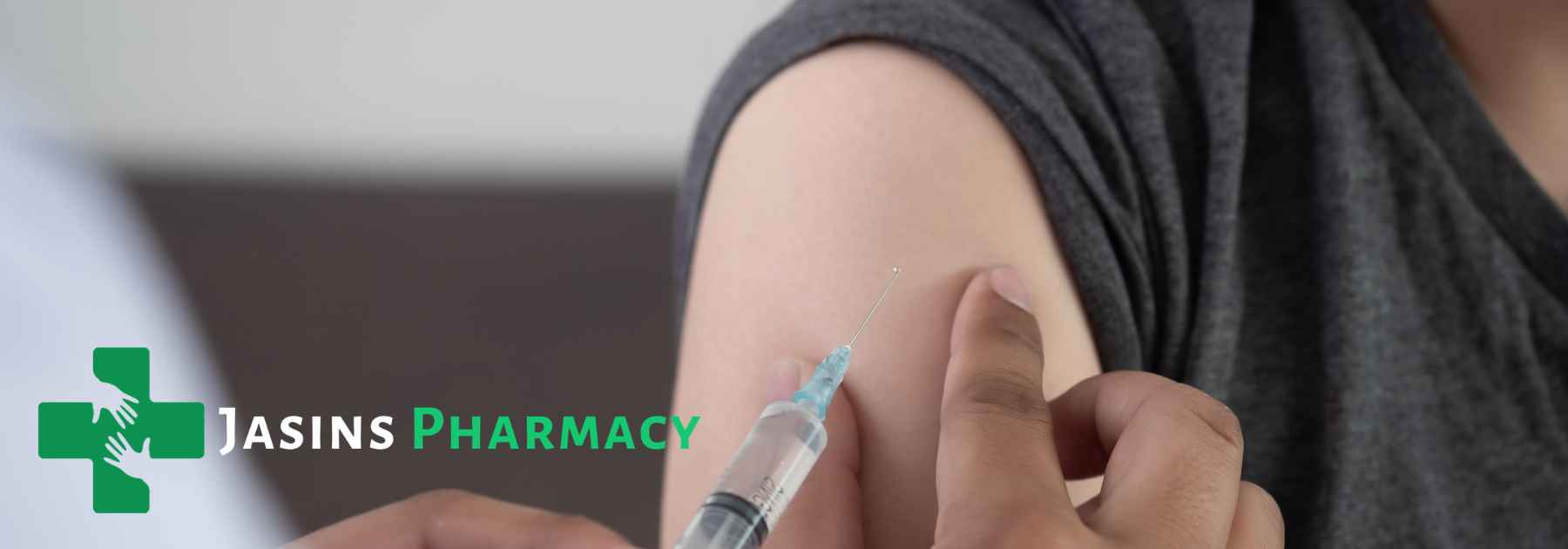 person in grey shirt receiving vaccine