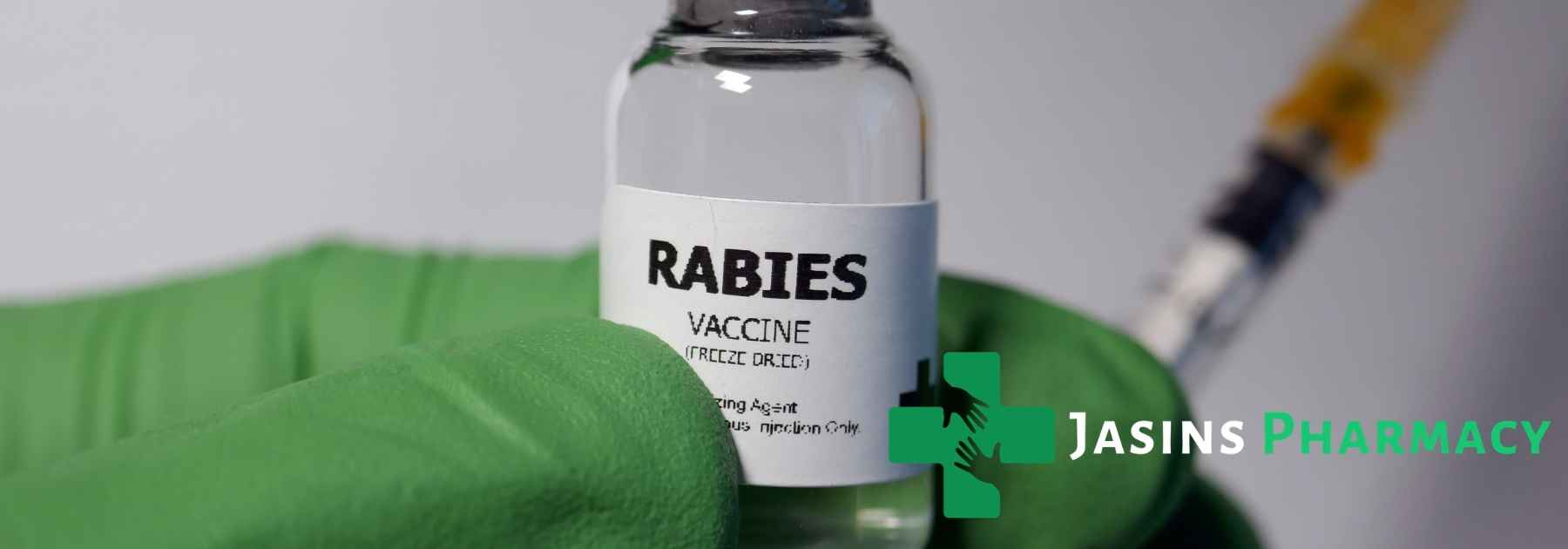 person wearing medical glove holding rabies vaccine