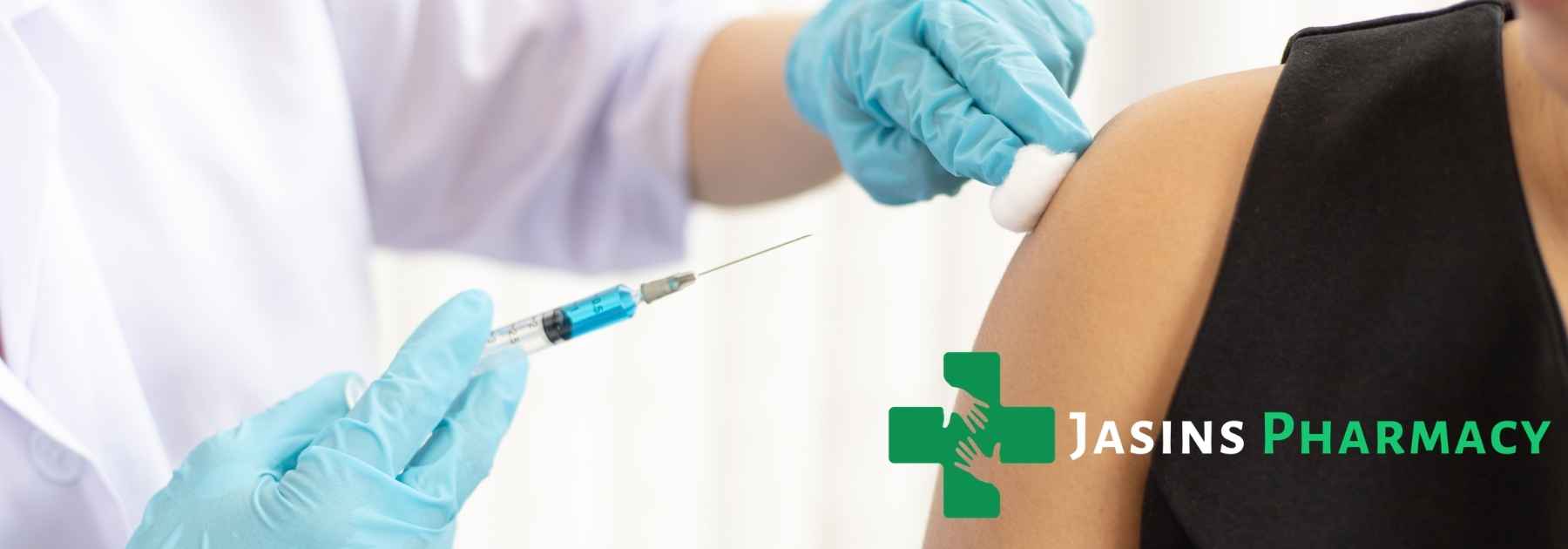 person in black shirt receiving vaccine